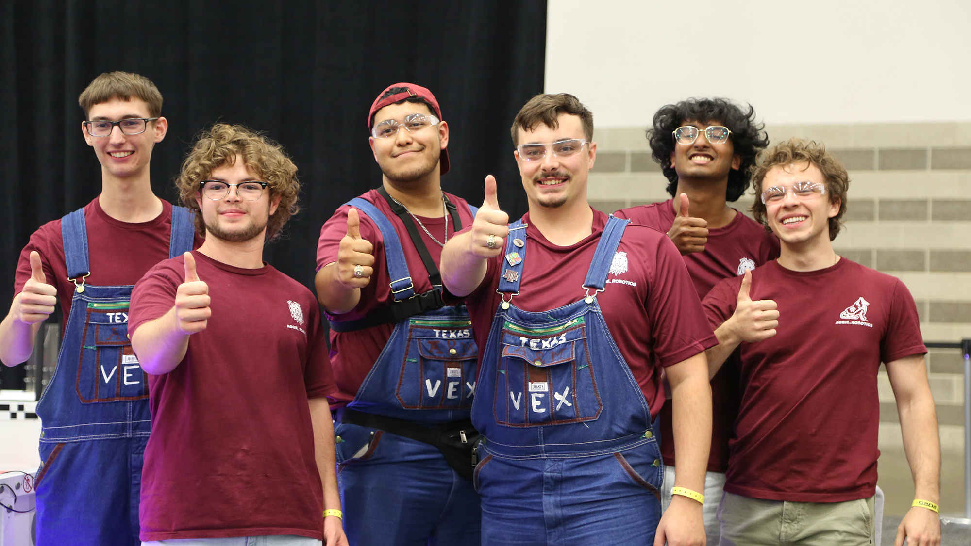 A group of people giving a thumbs up.