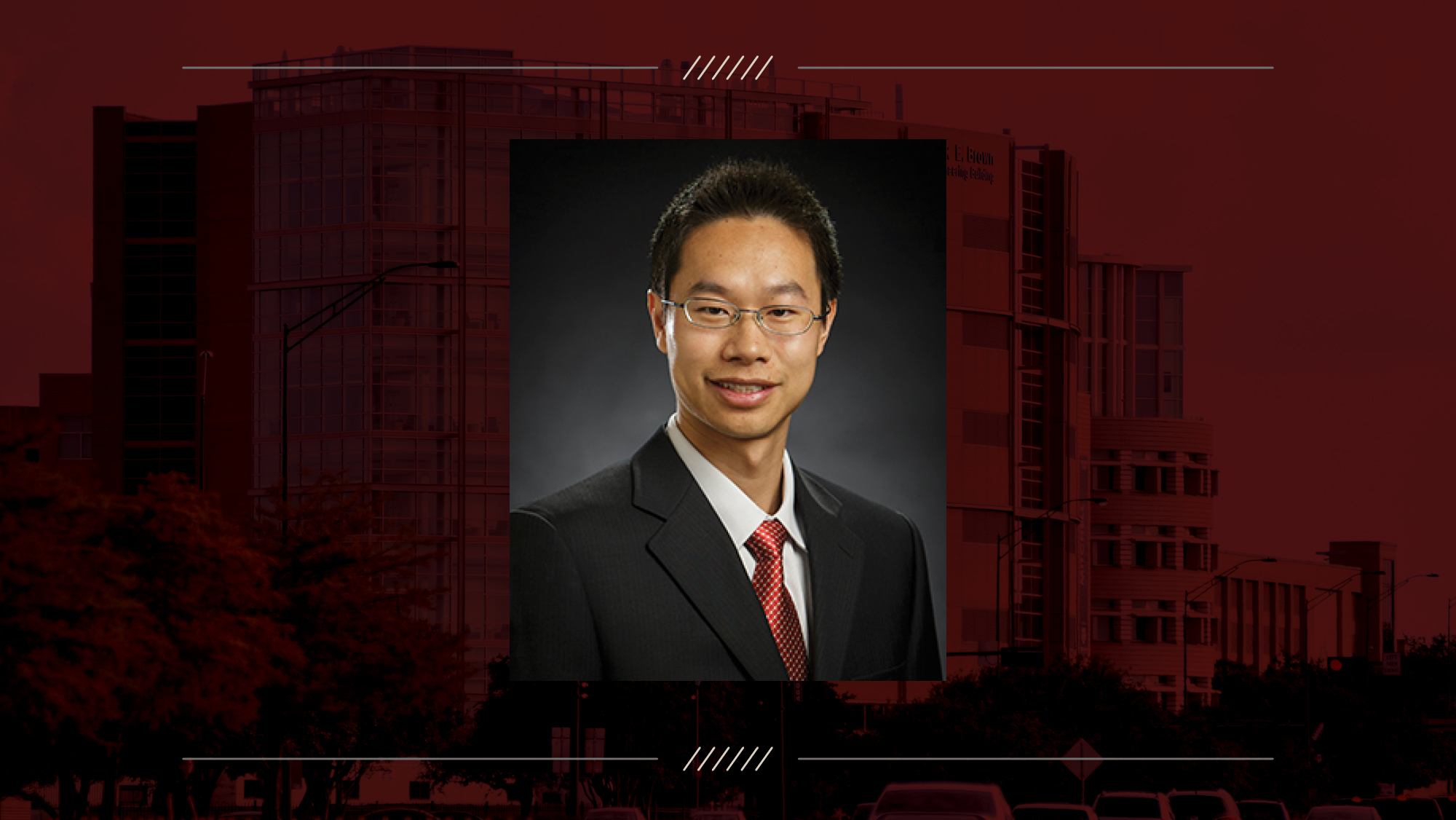 Headshot of a man on a maroon background.