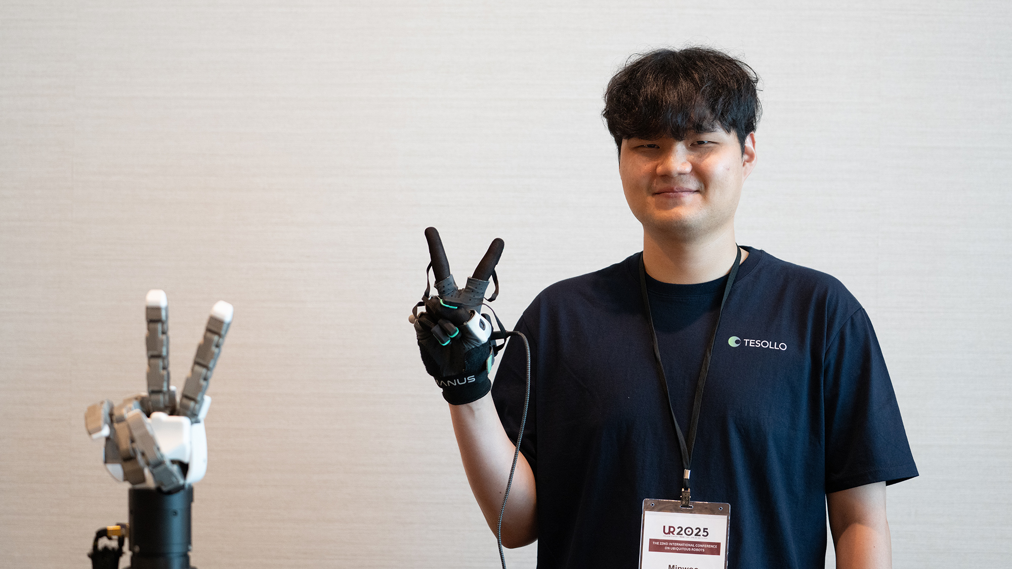Man posing with a robot hand.