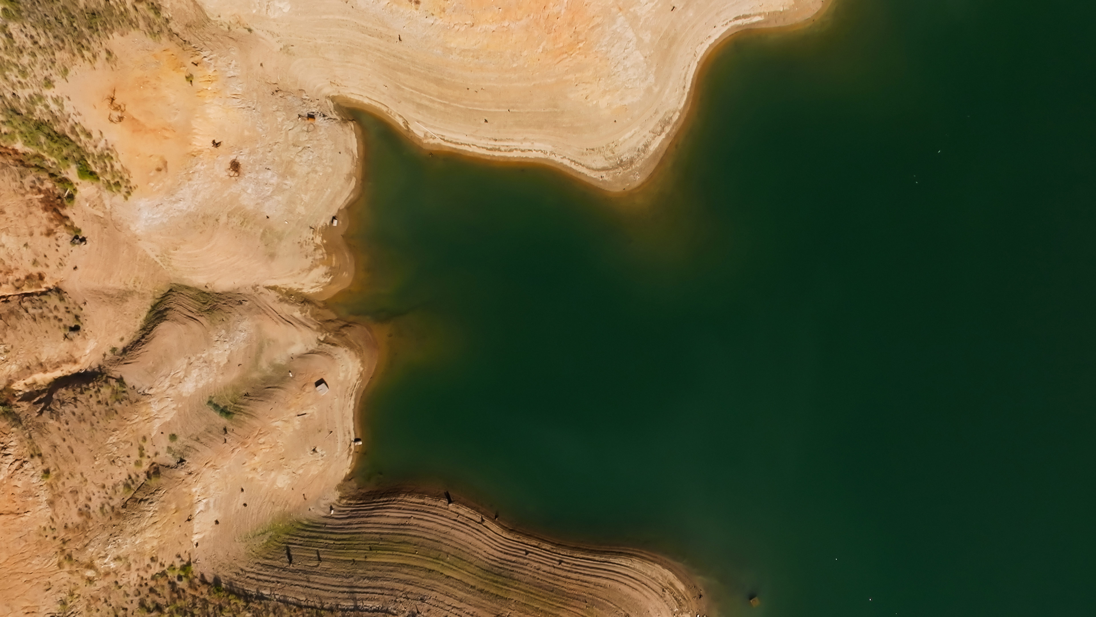 An image of a lake from above surrounded by arid landscape.