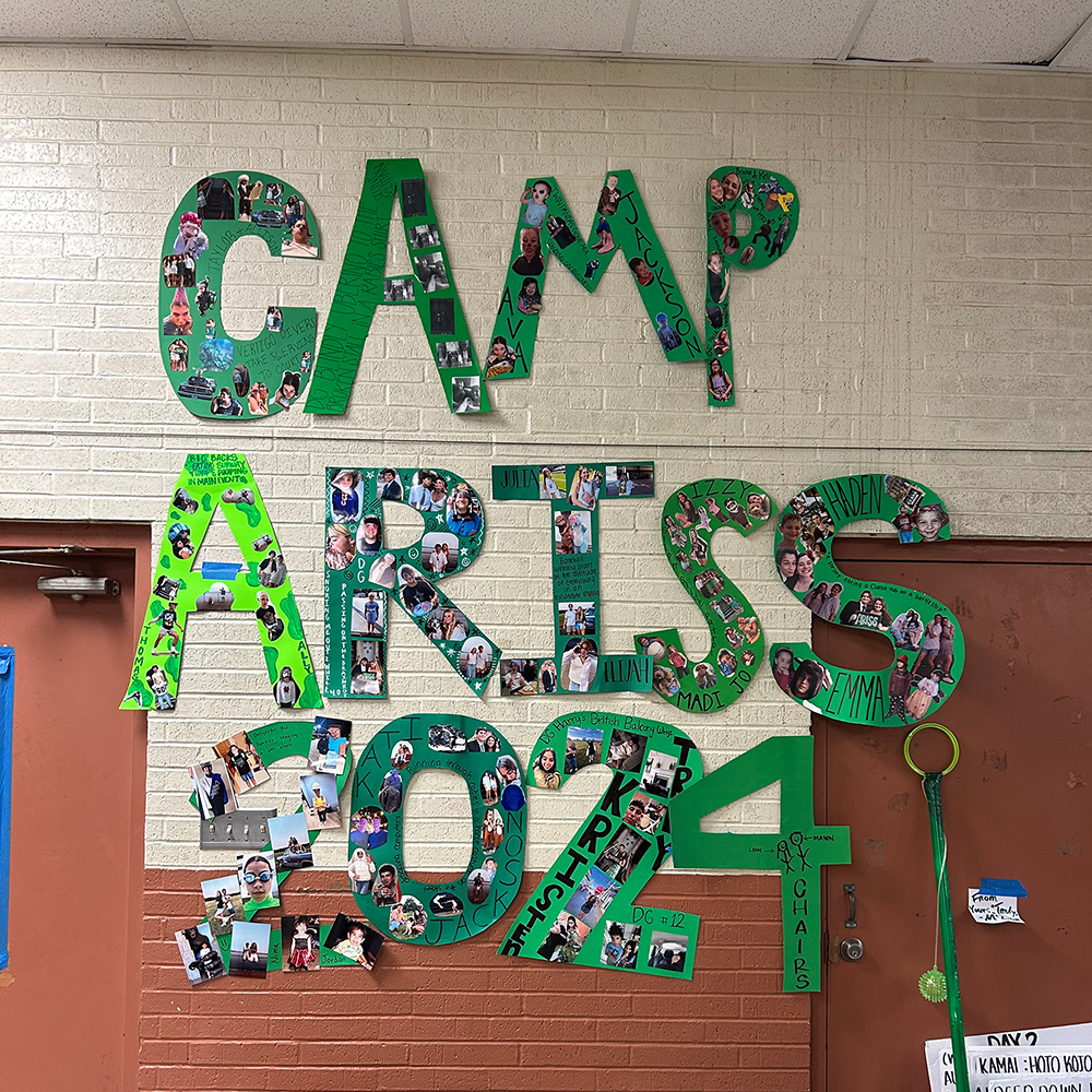 A wall decorated with cardboard letters and photos.