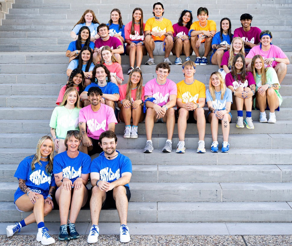 A group of people sitting in the shape of a P.