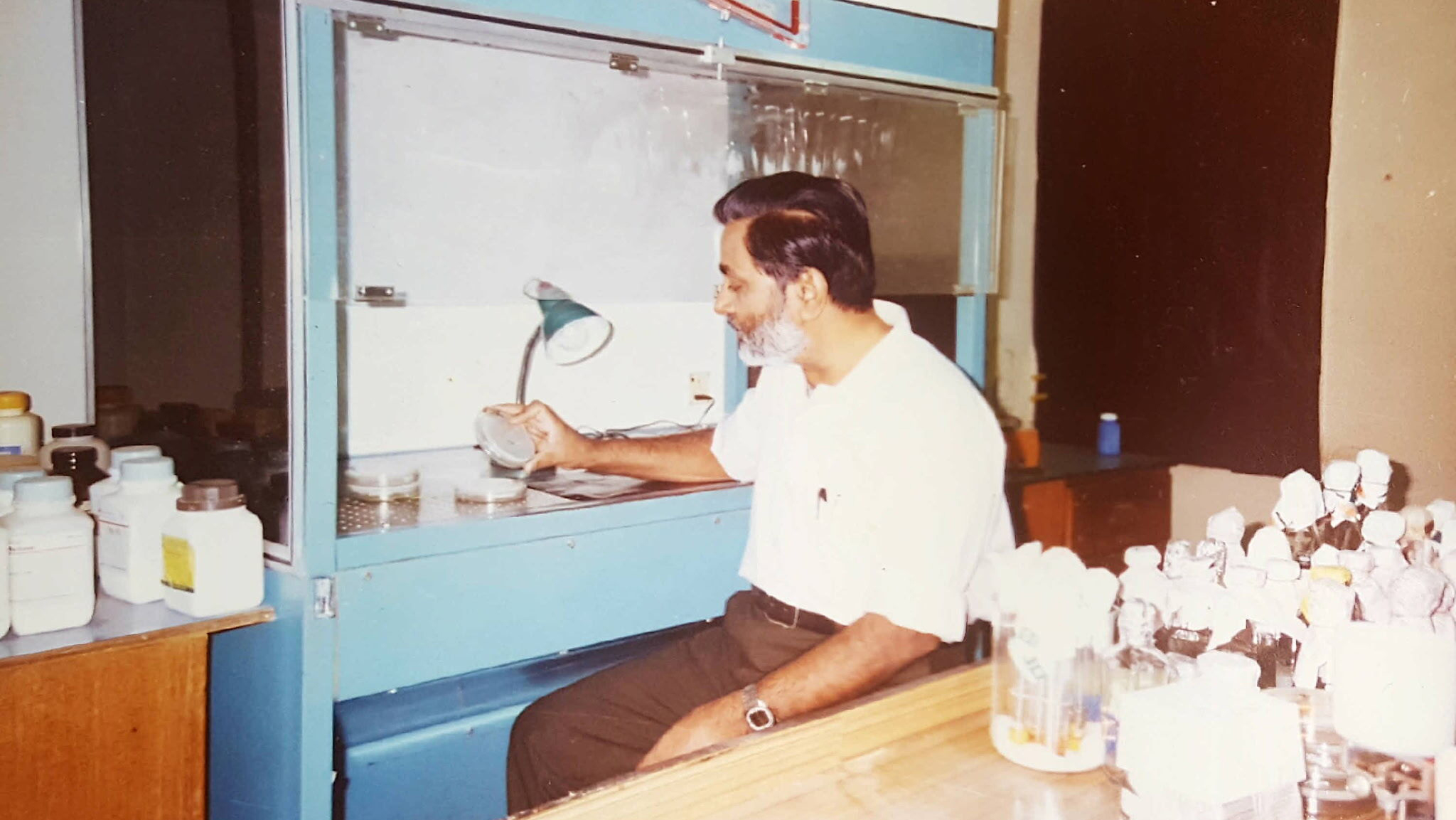 A man sitting in a lab. 