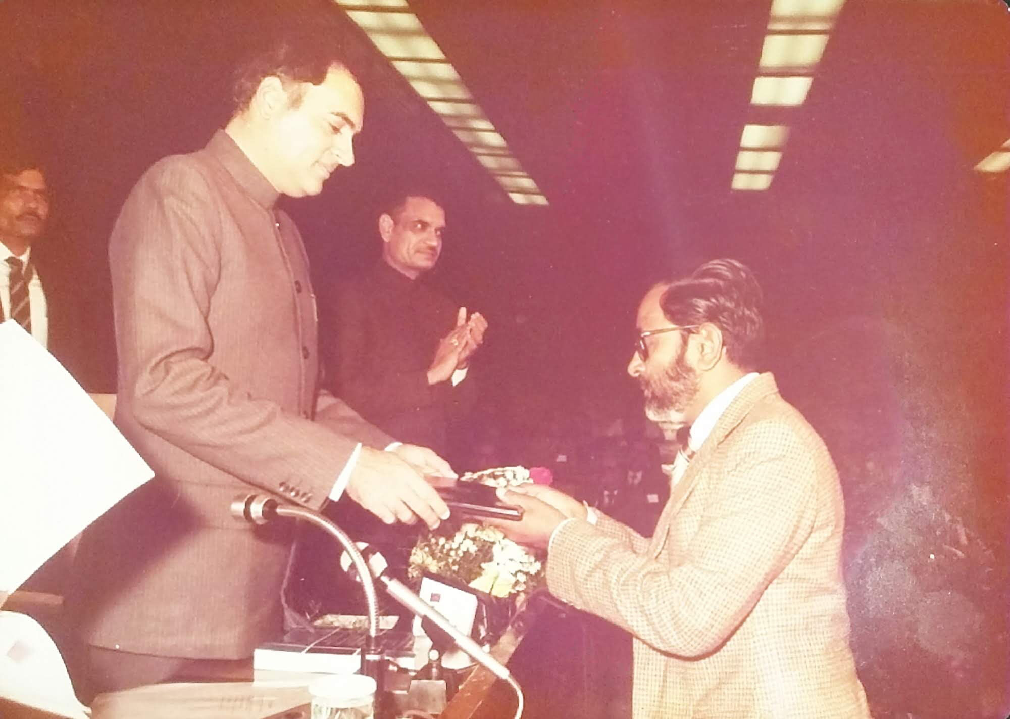A man receiving a plaque from another man. 