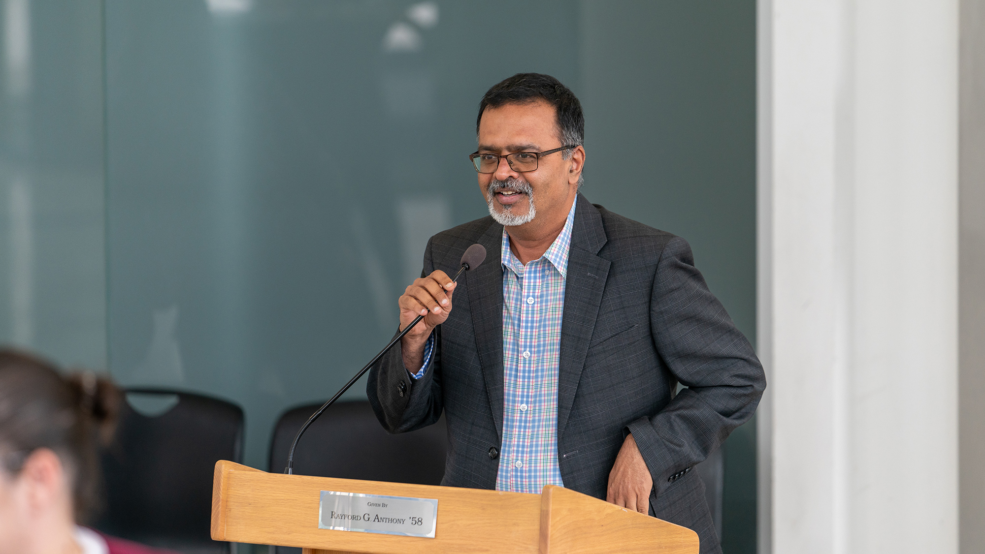 A man standing behind a podium, speaking.