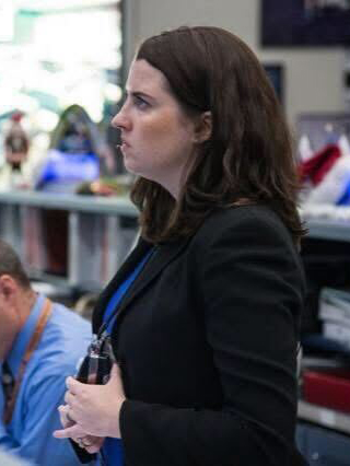 The side profile of a woman standing.