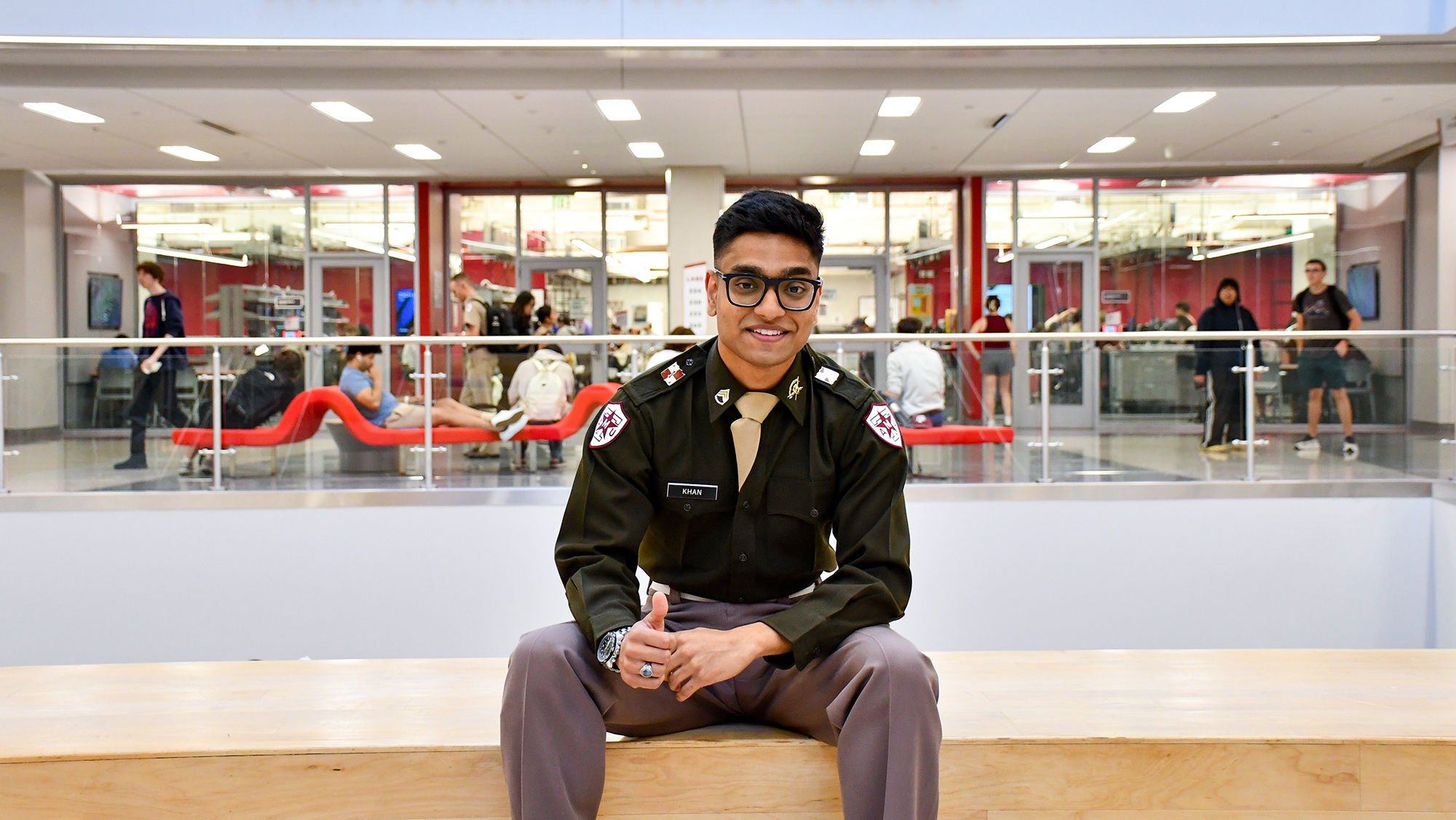 Abdul Samad Khan sitting on a bench and giving a thumbs up.