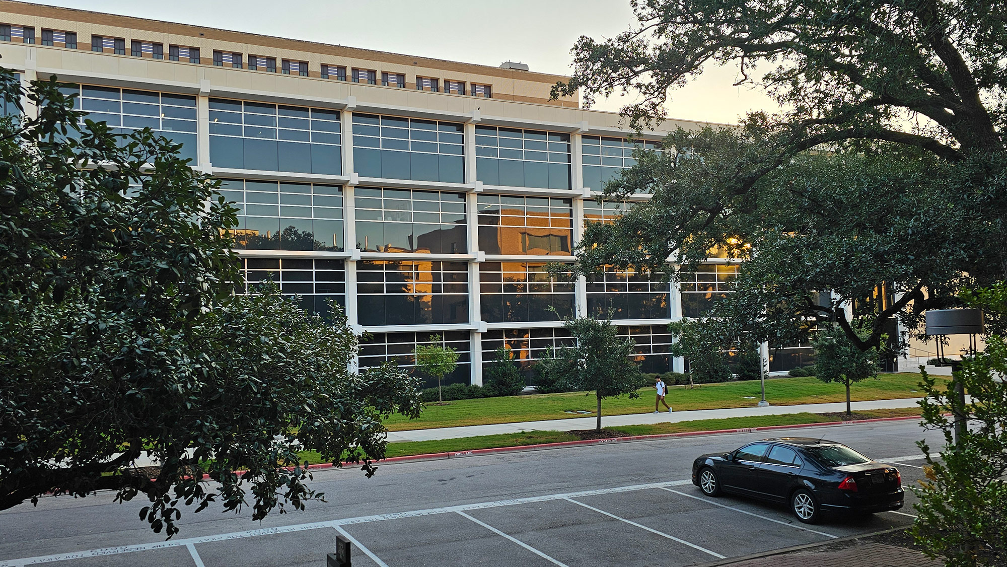 An office building with many large windows. 