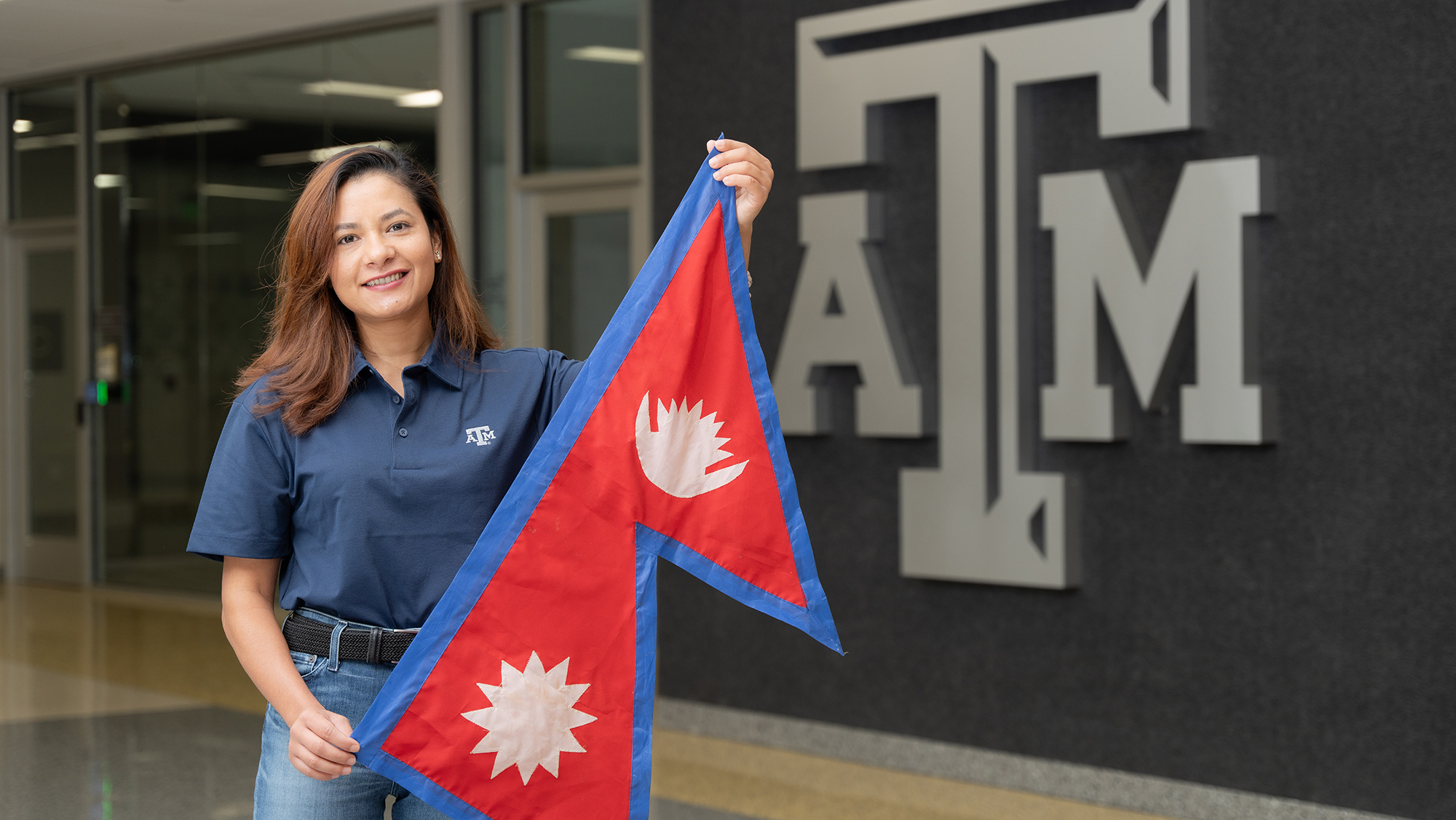 Jyoti KC posing with the flag of Nepal. 