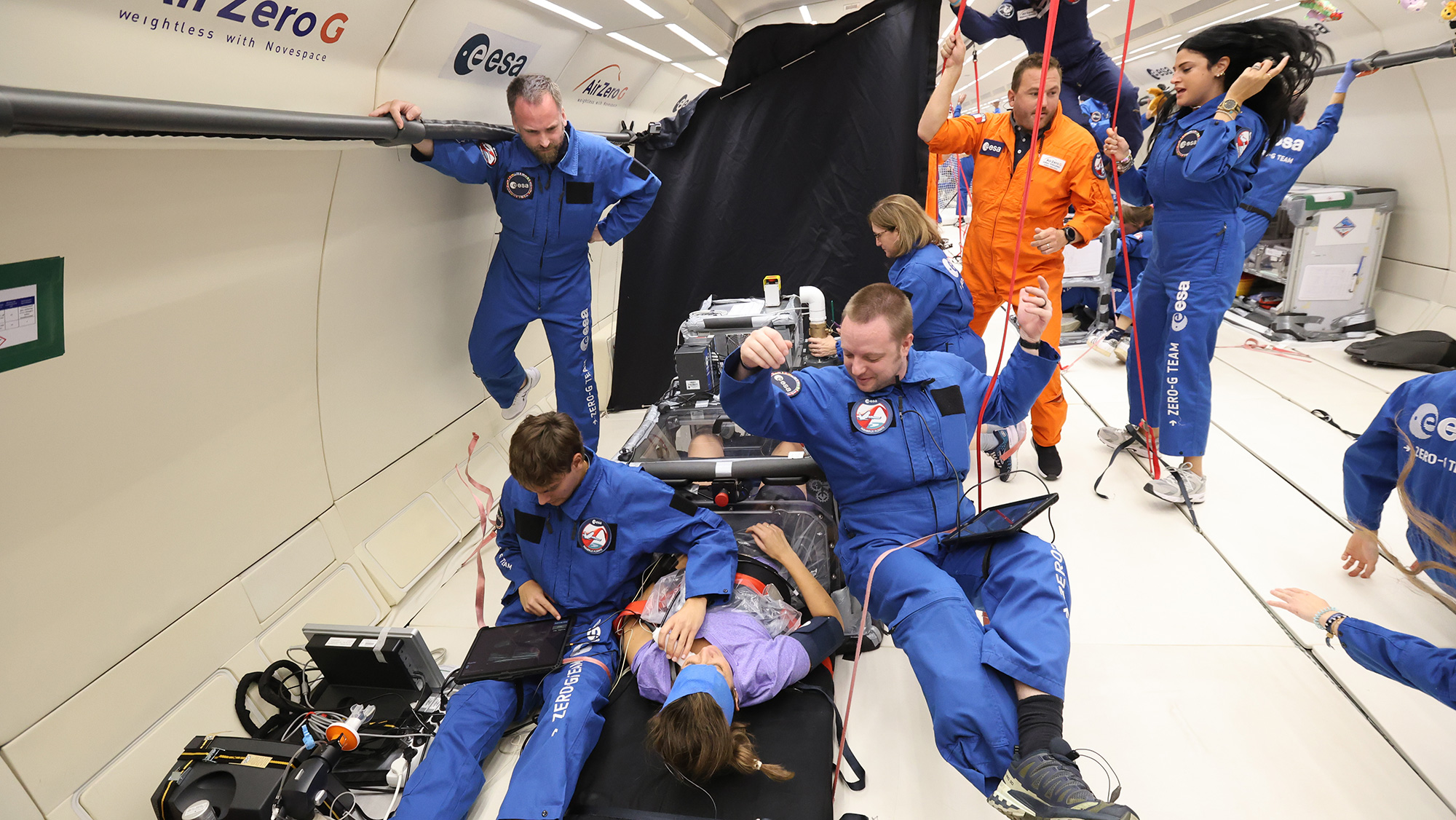 Researchers floating while performing experiments.