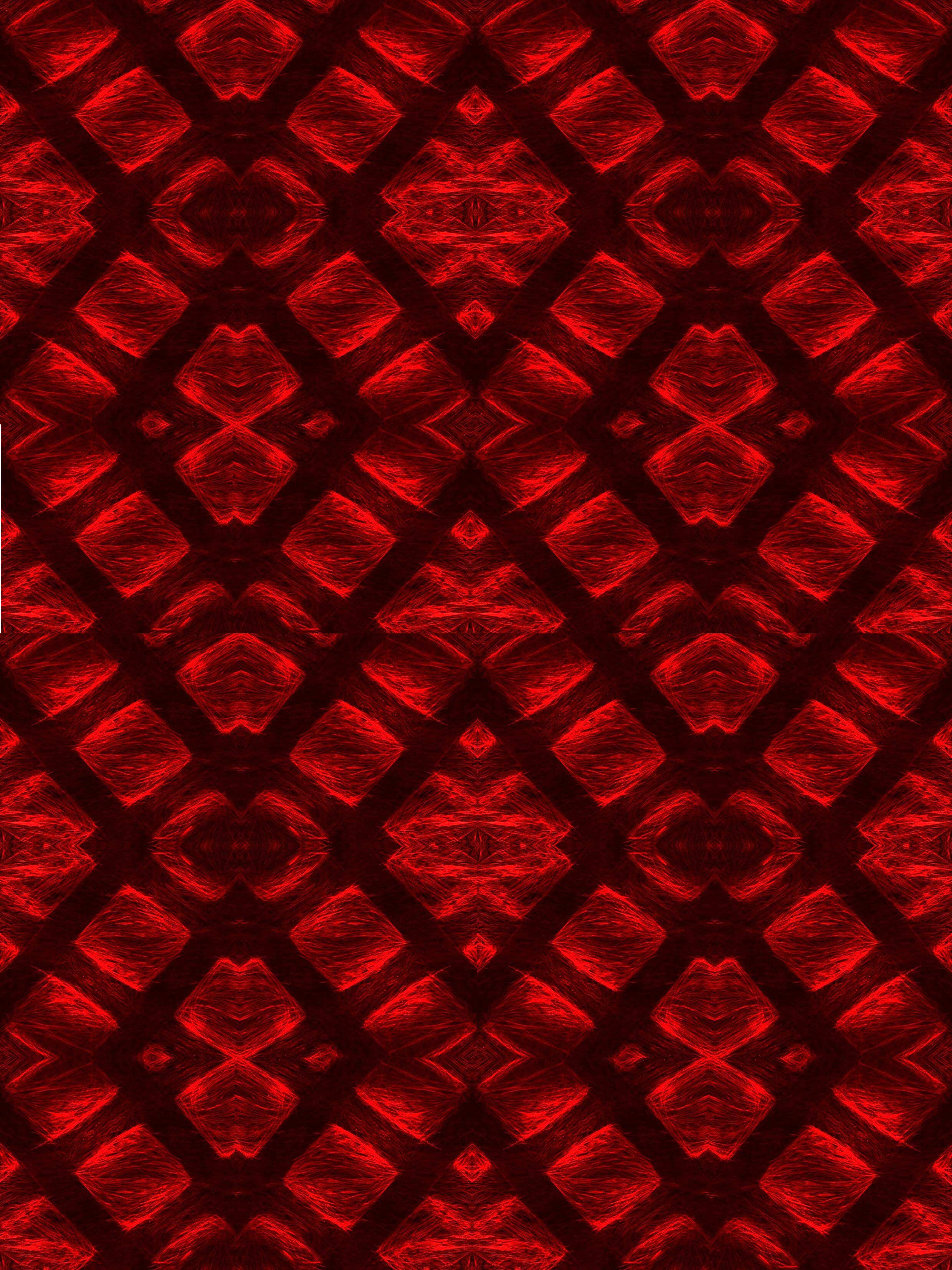 Microscopic red materials creating a symmetrical pattern. 