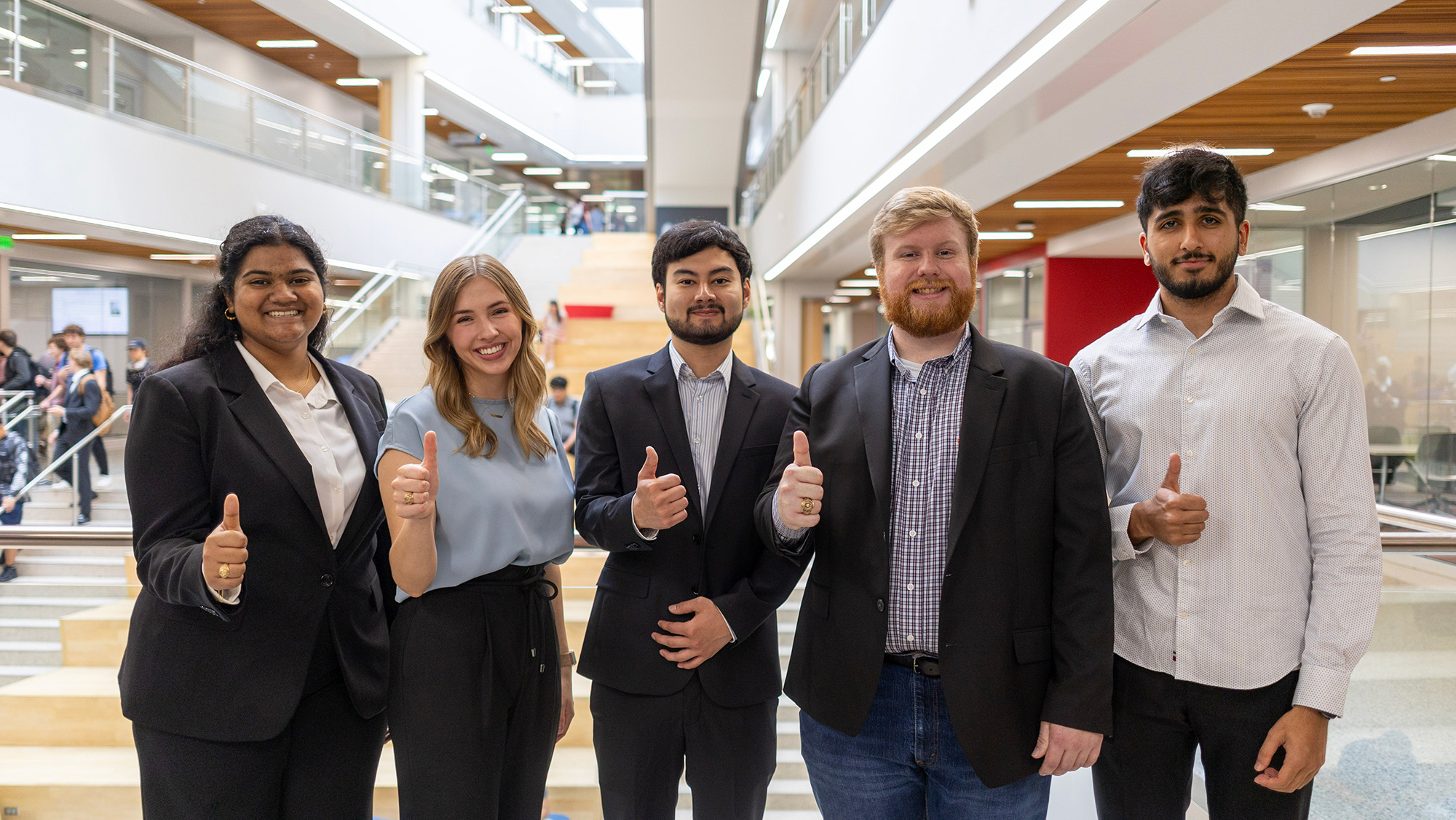Group of students giving a thumbs up.