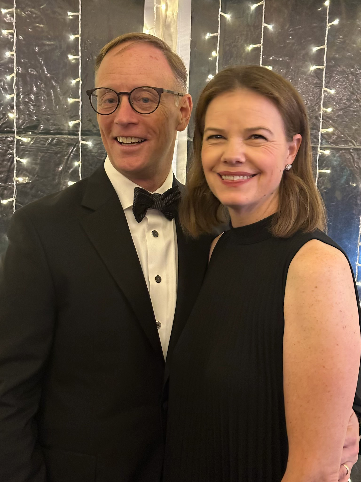 Man and woman stand for photo.