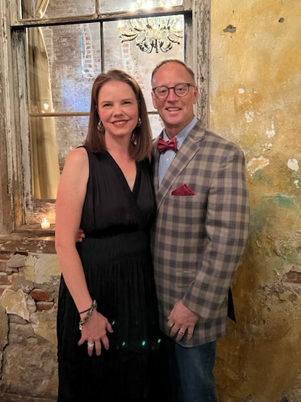 Man and woman stand for photo.