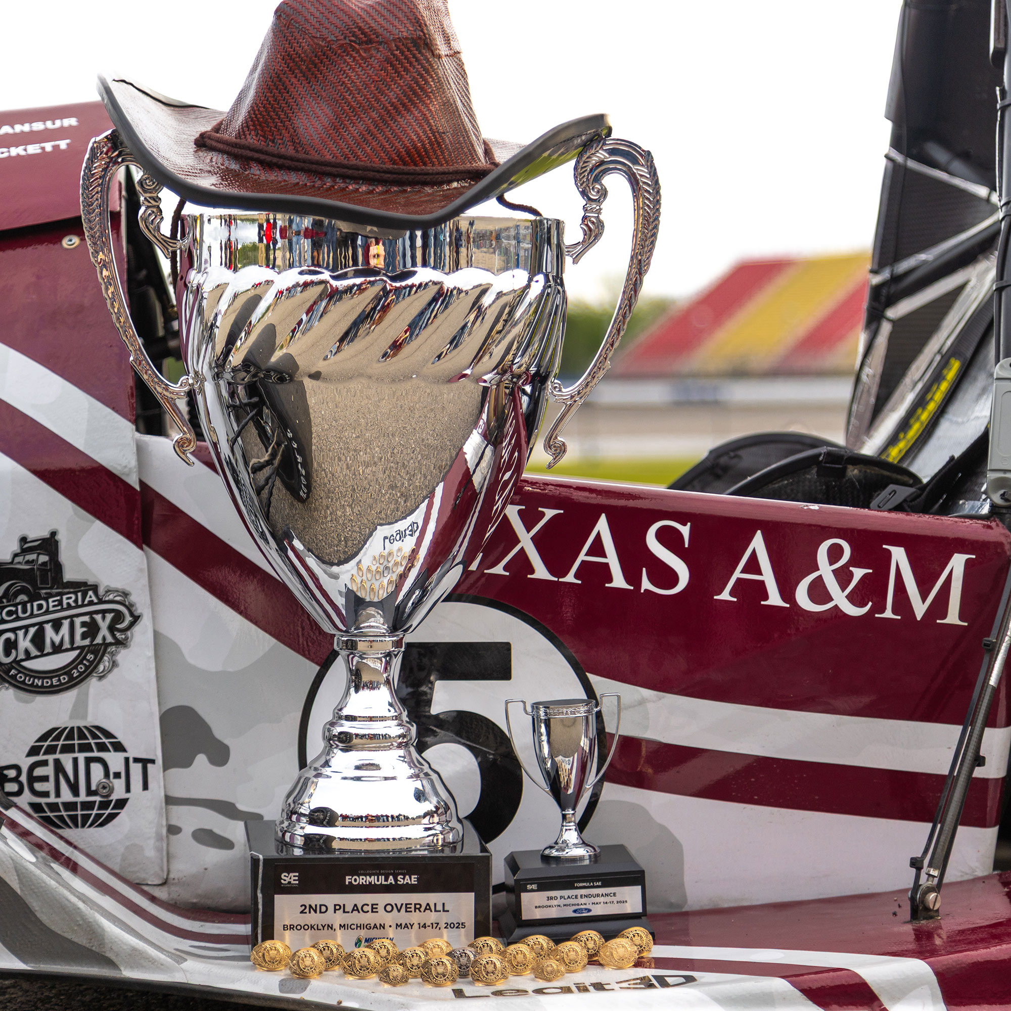 Two trophies with rings in front of them.