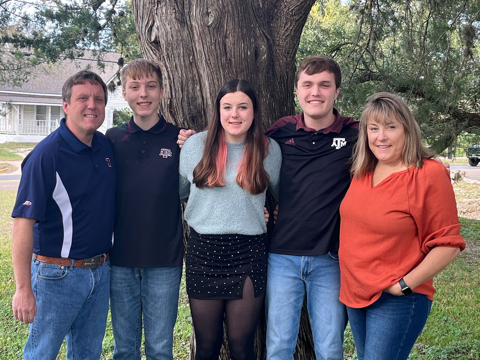 A family of five posing for a photo.