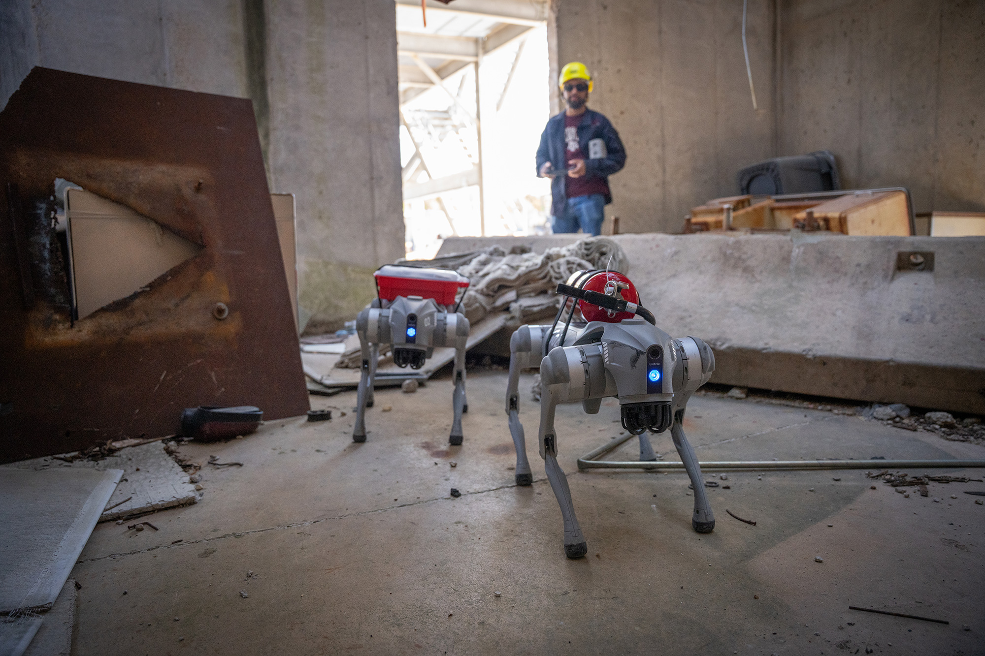 Two four-legged robots with a researcher behind them. 