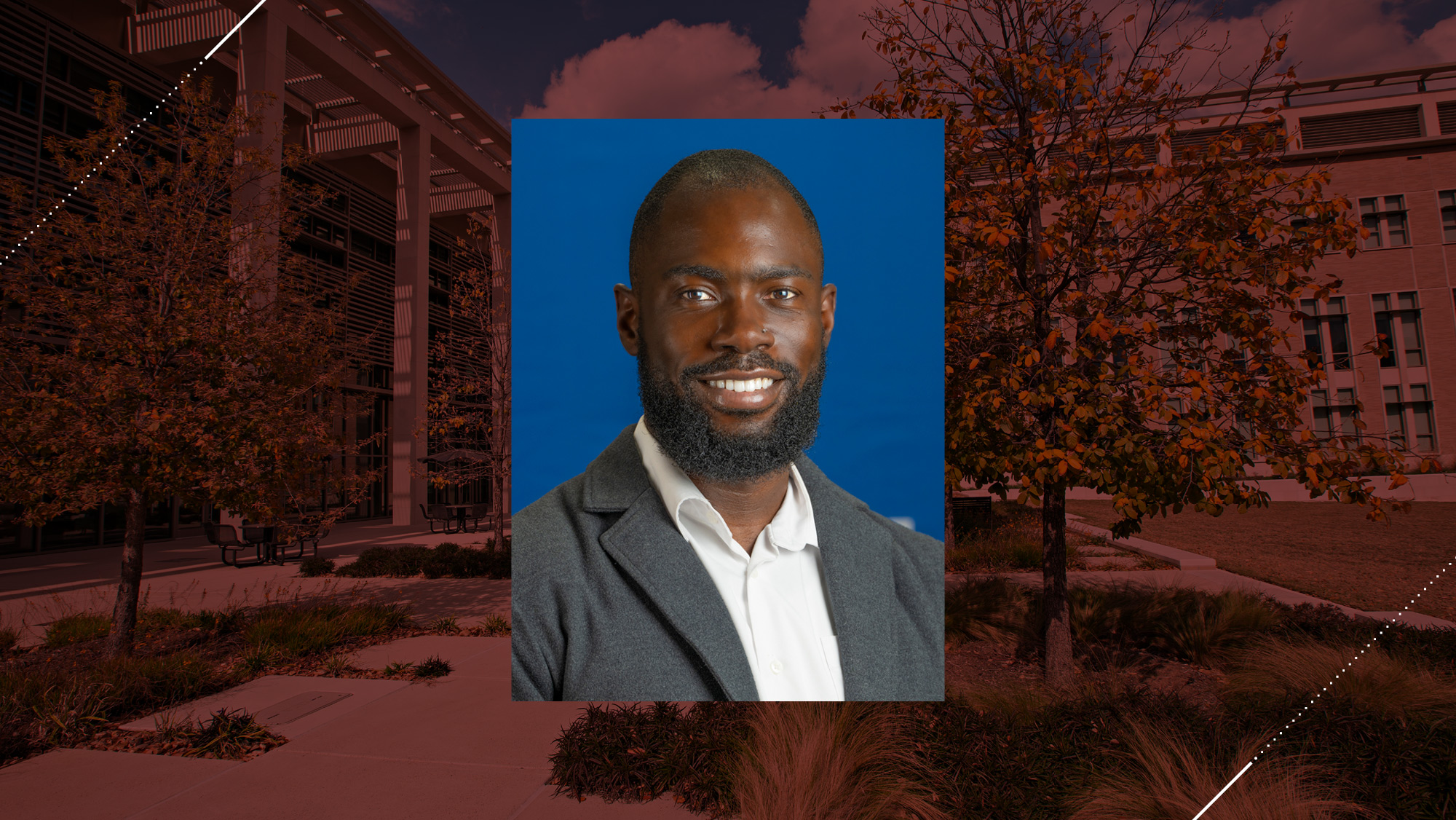 Headshot of a man on a maroon background. 