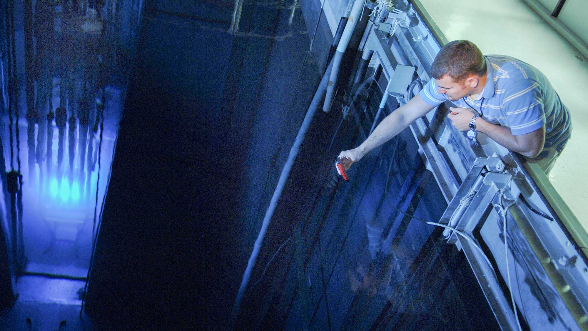 Male student measuring inside the nuclear lab.