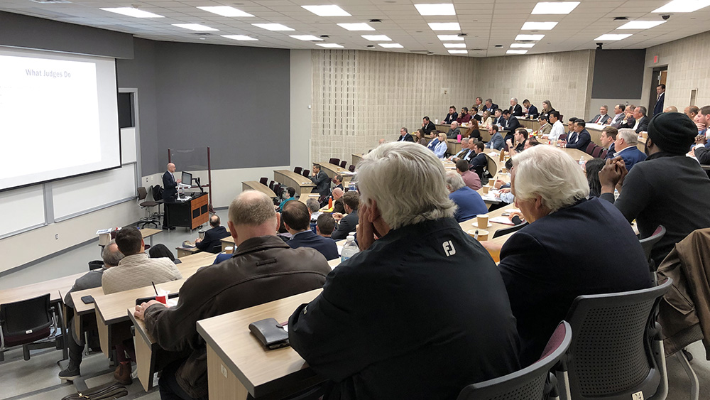 seated assembly of industry judges and moderators listening to presentation before the start of the 2022 Student Paper Contest in the Harold Vance Department of Petroleum Engineering