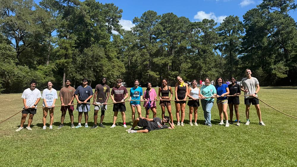A line of ZLP students holding a long rope.