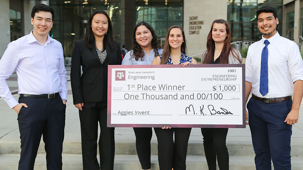 First place team smiling with their award.